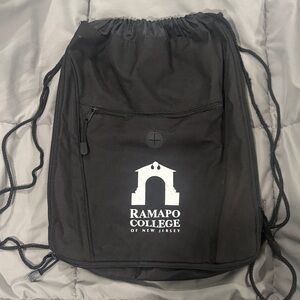 Ramapo College black sling bag backpack with front zipper pocket